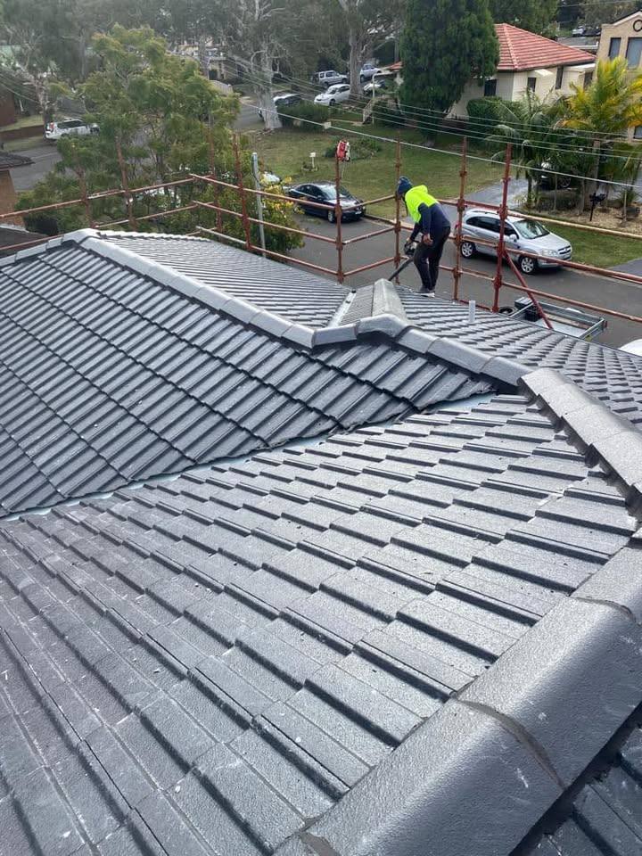 Charcoal tile roof, scaffold up and the crew on it, restoration under way.