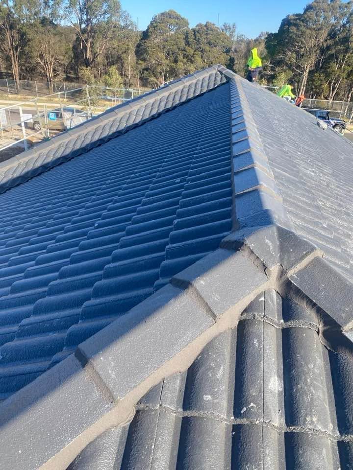 Slate blue tile roof, capping finished and set to a straight line.